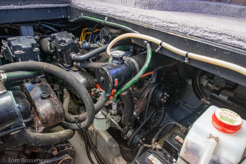 Slide: The Image of Engine compartment of a 1991 Sea Ray 370 Sedan Bridge boat, showing mechanical components. - 37