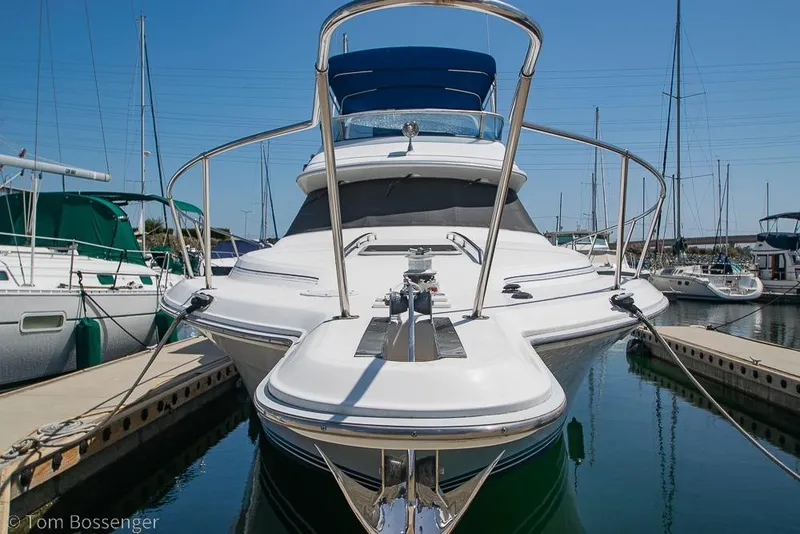 Slide: The Image of 1991 Sea Ray 370 Sedan Bridge yacht docked at marina under clear blue sky. - 5
