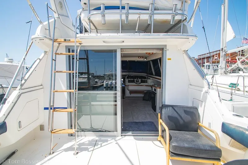 Slide: The Image of 1991 Sea Ray 370 Sedan Bridge yacht with open cabin and ladder, docked at marina. - 8