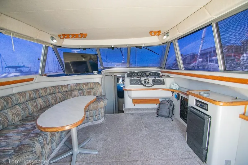 Slide: The Image of Interior of 1991 Sea Ray 370 Sedan Bridge with helm, seating, and panoramic windows. - 9
