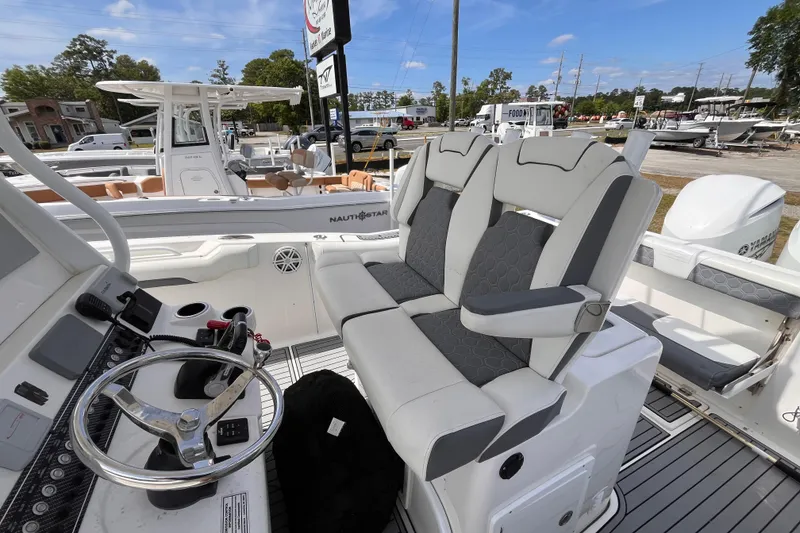Slide: The Image of 2019 Tidewater 280 CC Adventure boat interior with steering wheel and seating. - 10