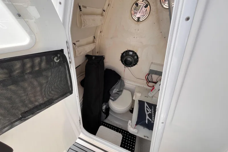 Slide: The Image of Interior of 2019 Tidewater 280 CC Adventure boat, featuring compact cabin amenities. - 11