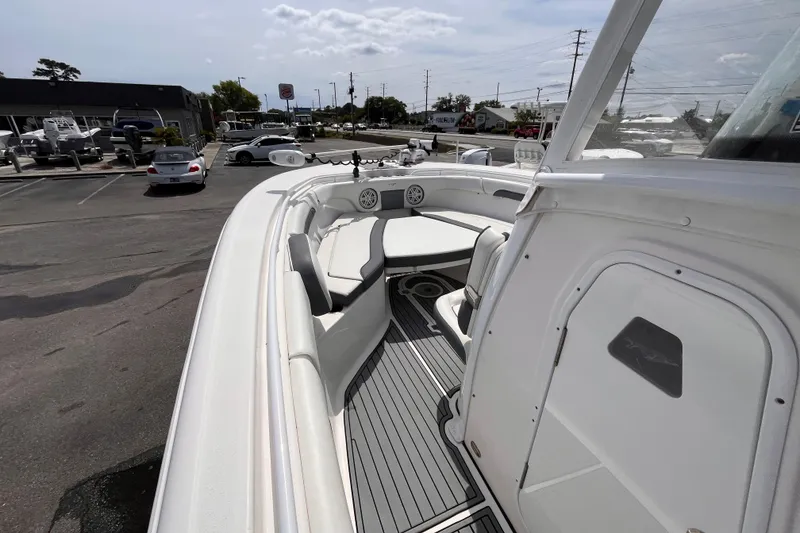 Slide: The Image of 2019 Tidewater 280 CC Adventure boat interior with seating and deck view. - 12