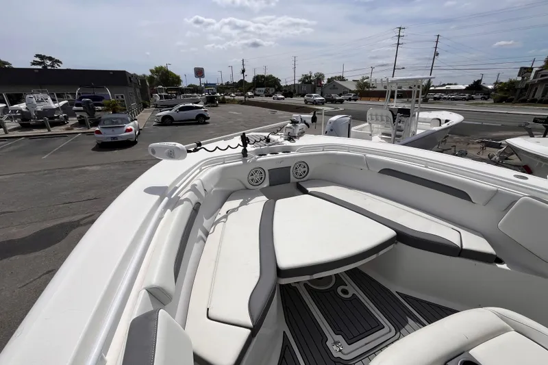 Slide: The Image of 2019 Tidewater 280 CC Adventure boat with spacious seating in a marina parking lot. - 13