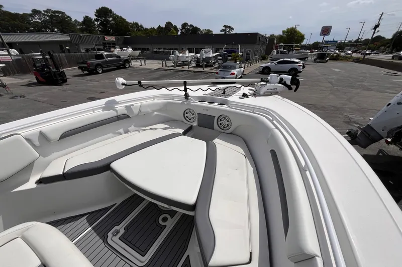 Slide: The Image of 2019 Tidewater 280 CC Adventure boat interior with seating and equipment in a parking lot. - 14