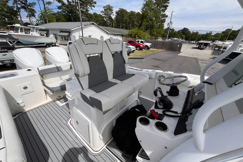 Slide: The Image of 2019 Tidewater 280 CC Adventure boat interior with dual seating and control console. - 16