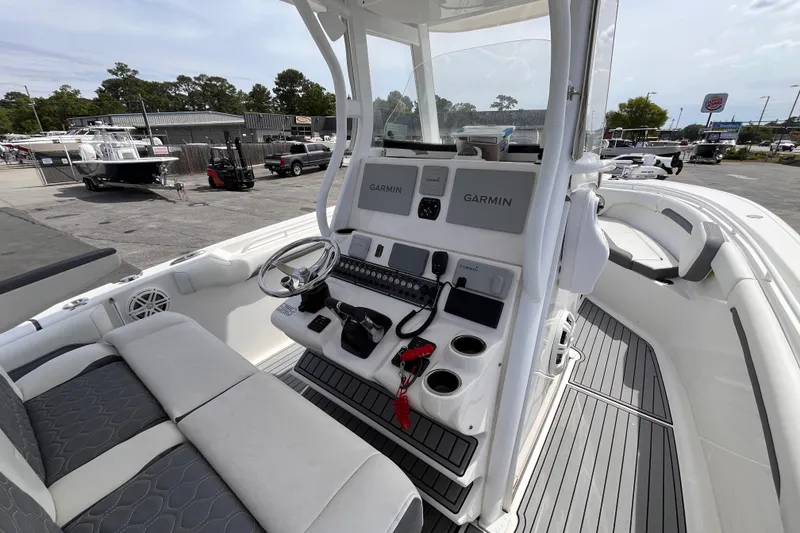 Slide: The Image of 2019 Tidewater 280 CC Adventure boat cockpit with Garmin navigation system and seating. - 18