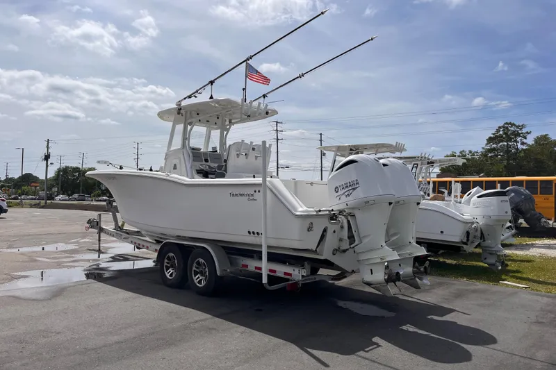 Slide: The Image of 2019 Tidewater 280 CC Adventure boat on trailer with dual Yamaha engines. - 2
