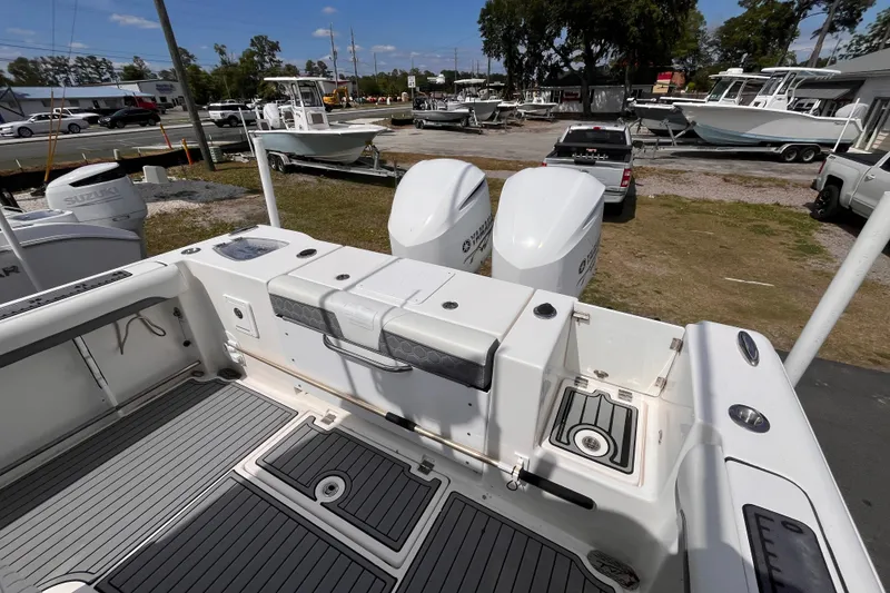 Slide: The Image of 2019 Tidewater 280 CC Adventure boat with dual engines, parked in a marina. - 5