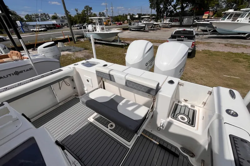 Slide: The Image of 2019 Tidewater 280 CC Adventure boat with dual Yamaha engines, docked outdoors. - 6