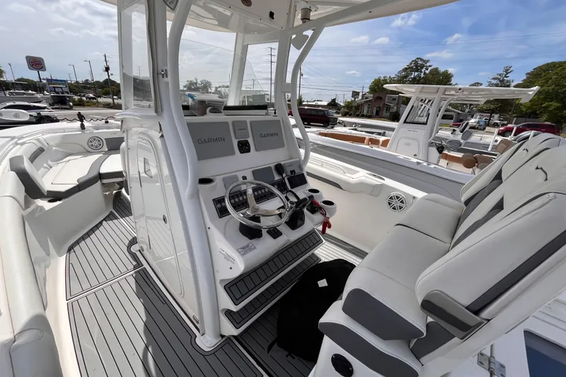 Slide: The Image of 2019 Tidewater 280 CC Adventure boat interior with Garmin navigation system and seating. - 8