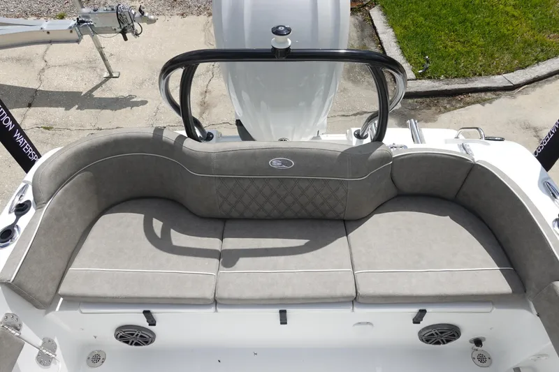 Slide: The Image of 2026 Sea Hunt Ultra 245 SE boat with spacious, cushioned seating area and modern design. - 11
