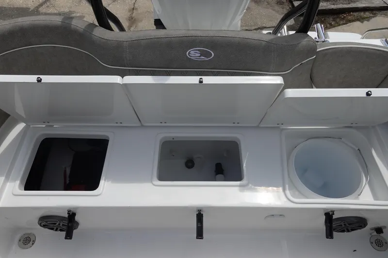 Slide: The Image of 2026 Sea Hunt Ultra 245 SE boat storage compartments and seating area. - 12