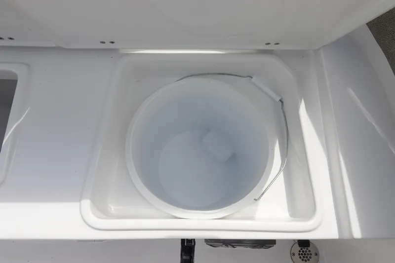 Slide: The Image of Livewell compartment on 2026 Sea Hunt Ultra 245 SE boat, featuring a white bucket. - 13