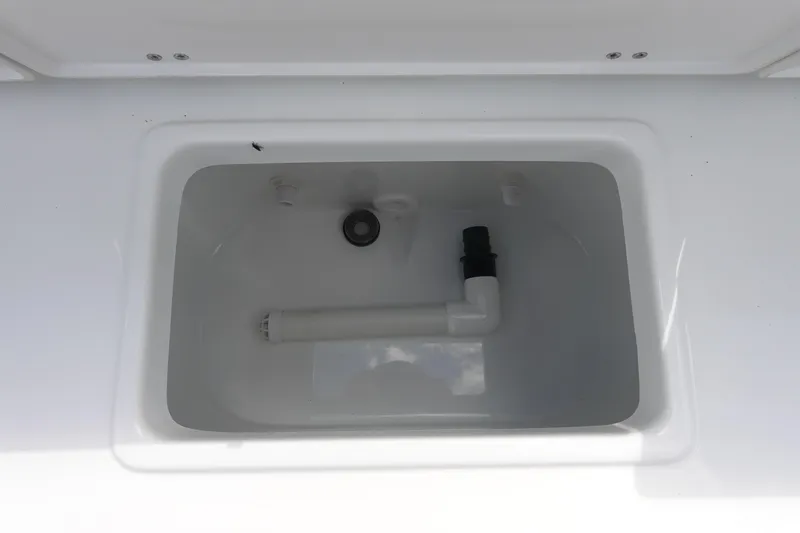 Slide: The Image of Livewell compartment in 2026 Sea Hunt Ultra 245 SE boat, featuring plumbing and drainage. - 14