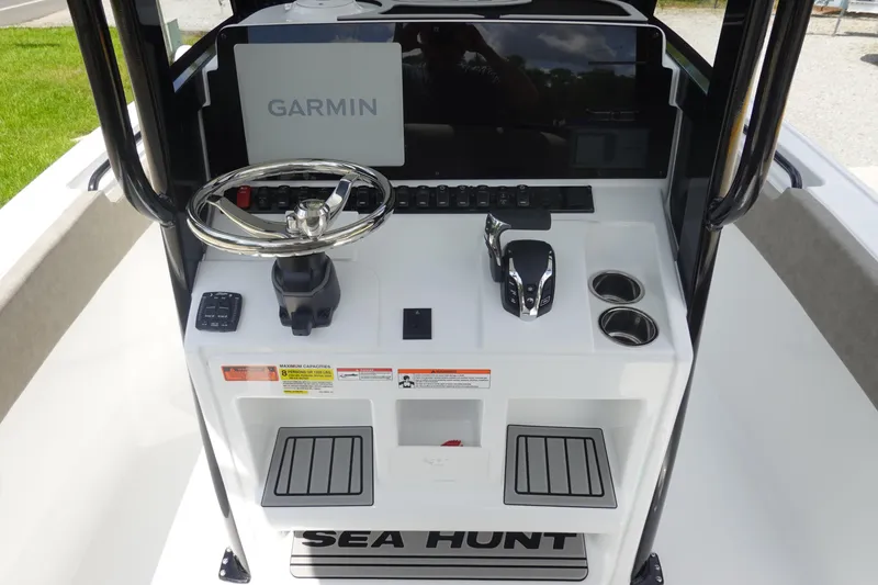Slide: The Image of 2026 Sea Hunt Ultra 245 SE boat console with Garmin display and steering wheel. - 22