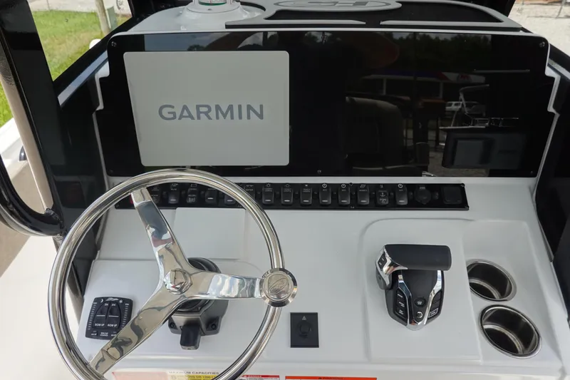 Slide: The Image of 2026 Sea Hunt Ultra 245 SE boat dashboard with Garmin navigation system and steering wheel. - 23