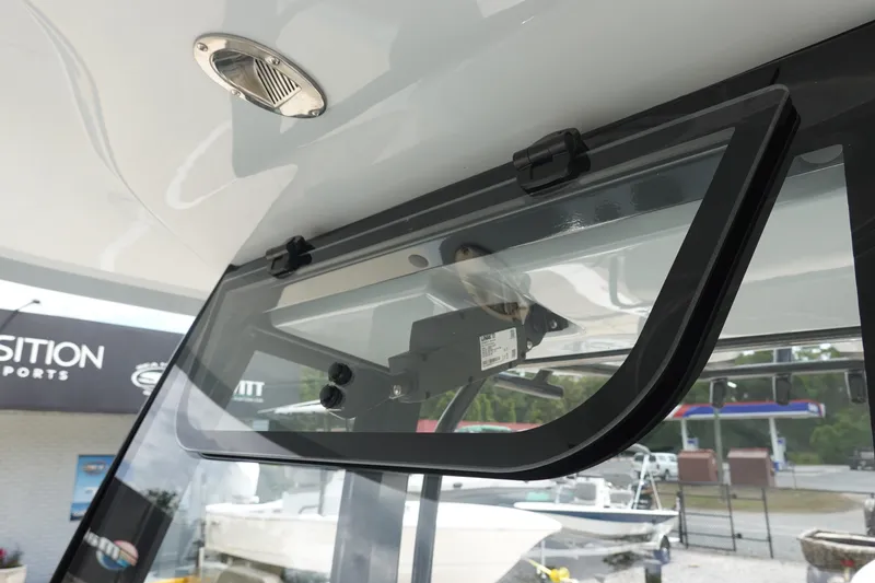 Slide: The Image of 2026 Sea Hunt Ultra 245 SE boat window detail with latch mechanism. - 28