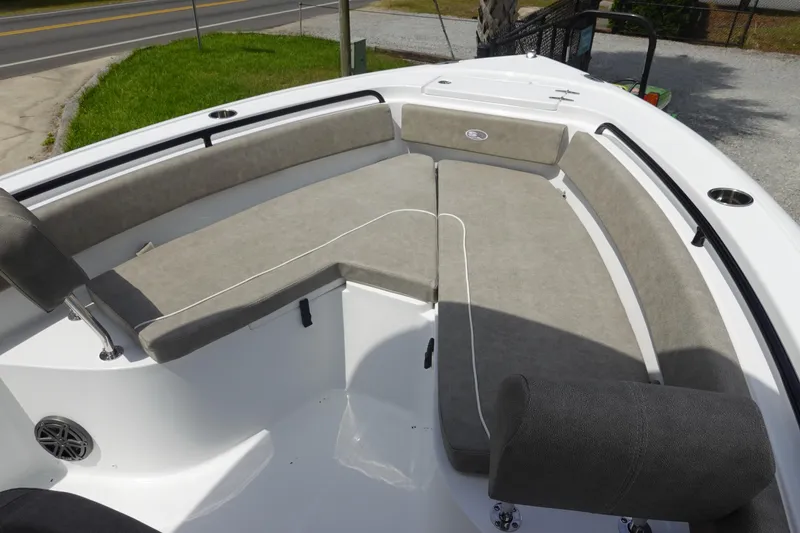 Slide: The Image of 2026 Sea Hunt Ultra 245 SE boat with spacious cushioned seating area. - 29