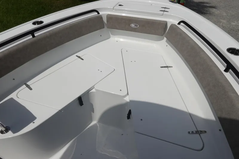 Slide: The Image of 2026 Sea Hunt Ultra 245 SE boat interior with cushioned seating and storage compartments. - 31