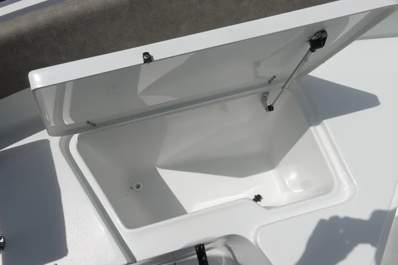 Slide: The Image of Open storage compartment on 2026 Sea Hunt Ultra 245 SE boat, showcasing interior space. - 34