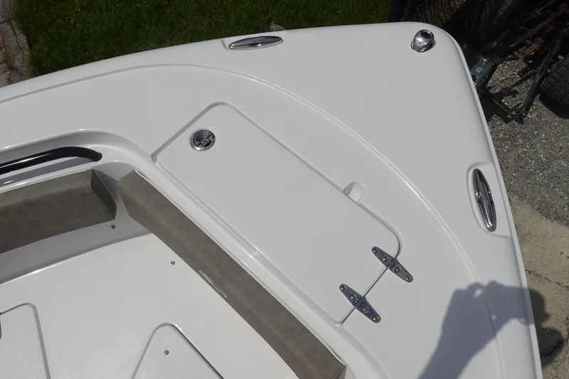 Slide: The Image of Bow area of 2026 Sea Hunt Ultra 245 SE boat, featuring storage compartment and seating. - 35