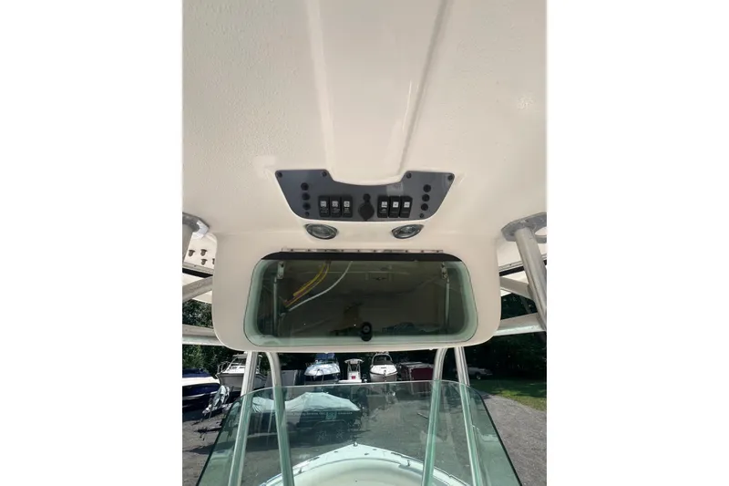 Slide: The Image of 2005 Robalo R220 Center Console boat dashboard with control panel and windshield. - 3