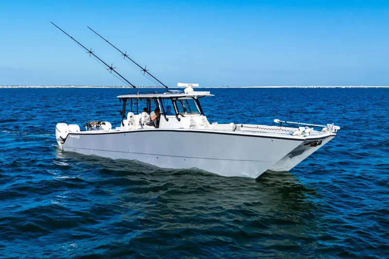 Slide: The Image of 2022 Freeman 42LR boat cruising on open blue water under clear skies. - 14