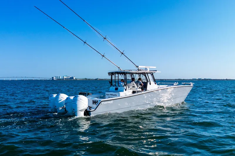 Slide: The Image of 2022 Freeman 42LR boat cruising on open water under clear blue sky. - 15