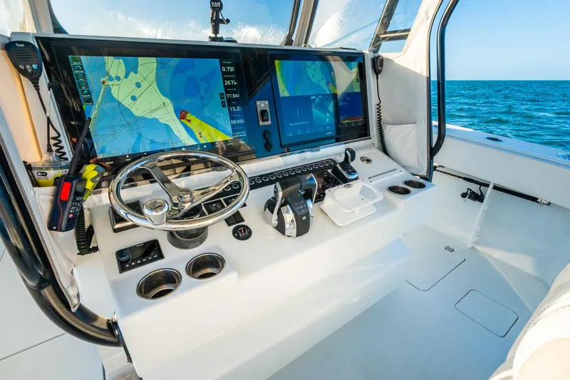 Slide: The Image of Freeman 42LR 2022 boat cockpit with navigation screens and steering wheel on open sea. - 26