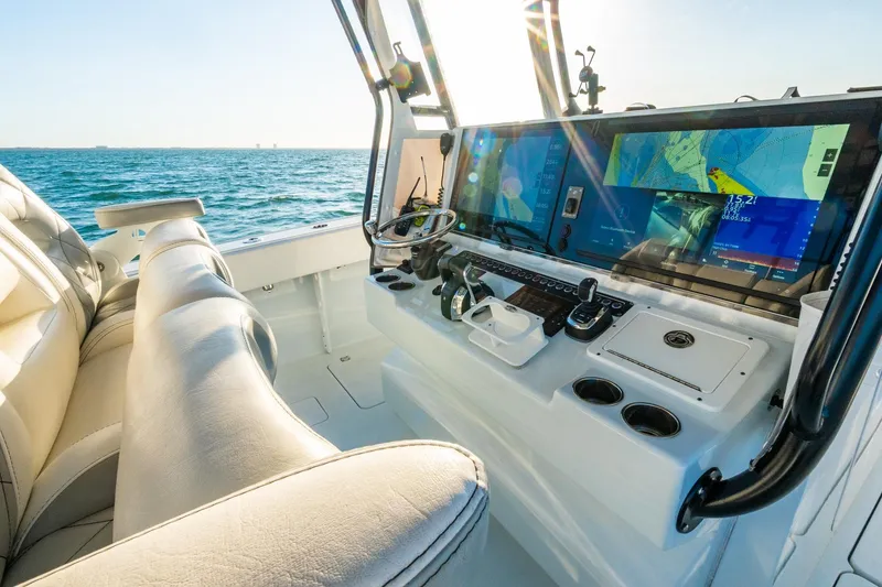 Slide: The Image of Luxurious 2022 Freeman 42LR boat cockpit with advanced navigation screens and plush seating. - 28