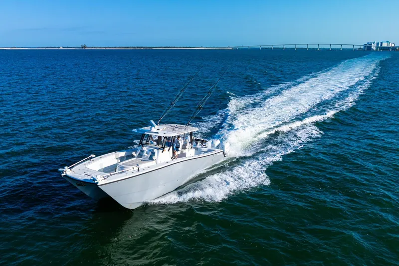 Slide: The Image of Freeman 42LR 2022 boat cruising on open water near a bridge. - 3