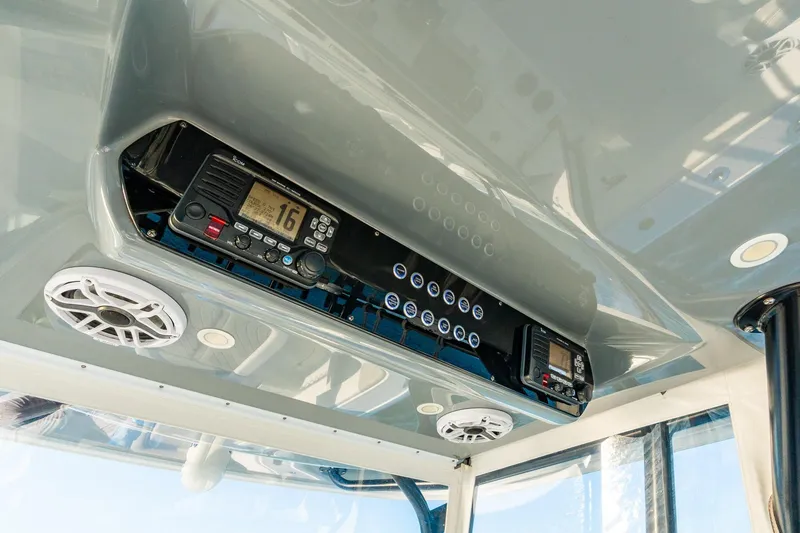 Slide: The Image of Overhead console of 2022 Freeman 42LR boat with radio and speakers. - 31