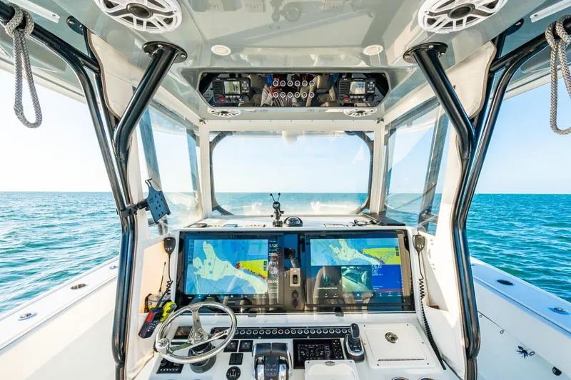 Slide: The Image of Cockpit view of 2022 Freeman 42LR boat with advanced navigation systems on open sea. - 33