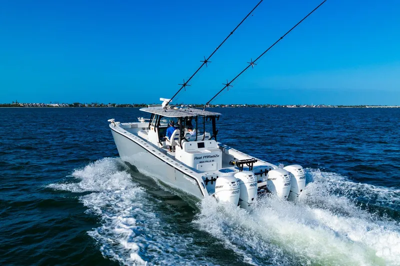 Slide: The Image of 2022 Freeman 42LR boat cruising on open water with four powerful engines. - 4