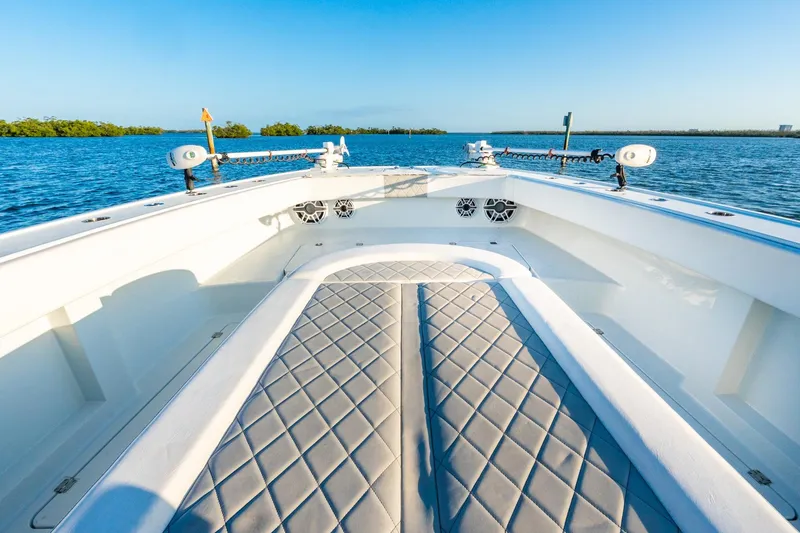 Slide: The Image of Luxurious 2022 Freeman 42LR boat interior with diamond-stitched seating on calm blue waters. - 47