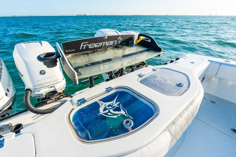 Slide: The Image of Freeman 42LR boat, 2022 model, with dual outboard motors on open water. - 52