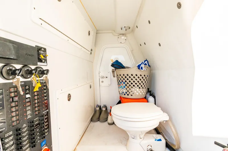 Slide: The Image of Interior of 2022 Freeman 42LR boat with toilet, control panel, and storage basket. - 61