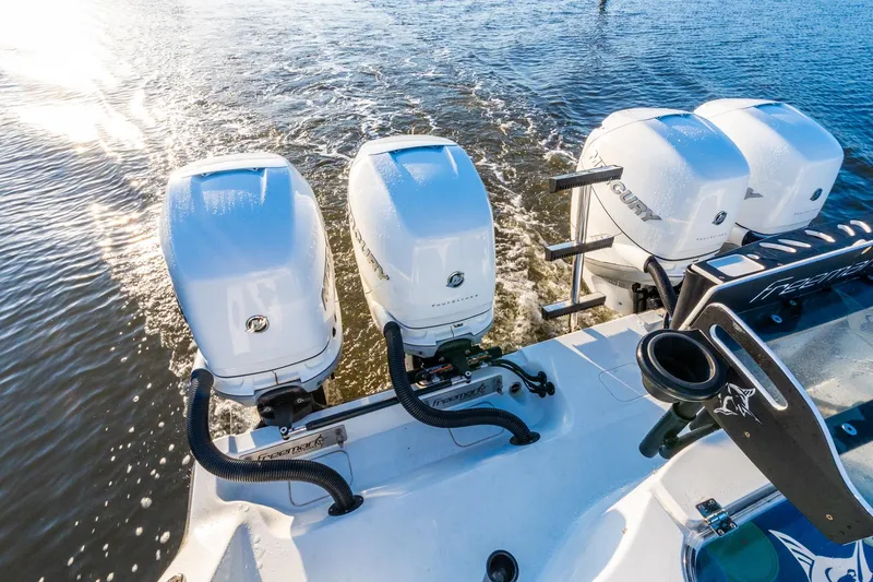 Slide: The Image of Four powerful Mercury outboard engines on a 2022 Freeman 42LR boat cruising through water. - 63