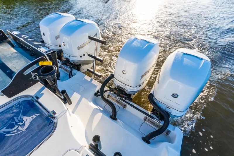 Slide: The Image of Four Mercury outboard engines on a 2022 Freeman 42LR boat in water. - 64