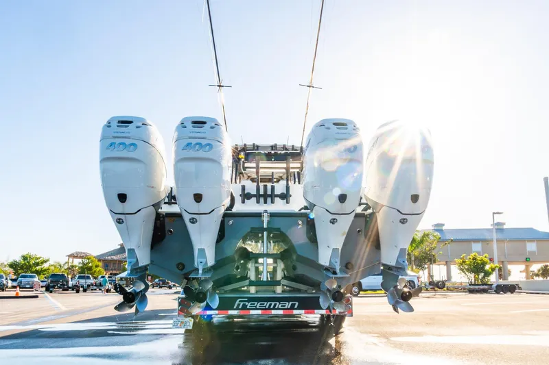 Slide: The Image of Freeman 42LR 2022 boat with four powerful outboard engines in a sunny marina. - 68