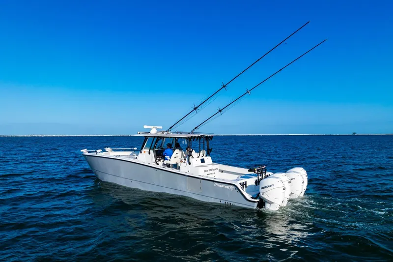 Slide: The Image of 2022 Freeman 42LR boat with fishing rods on open water under clear blue sky. - 7