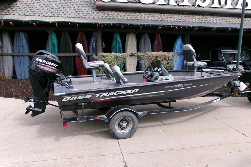 Slide: The Image of 2015 Bass Tracker Pro 17 boat with Mercury engine, parked outside a store. - 8