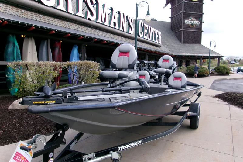 Slide: The Image of 2015 Bass Tracker Pro 17 boat displayed outside a sportsman's center. - 9