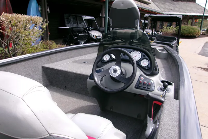 Slide: The Image of 2015 Bass Tracker Pro 17 boat interior with steering wheel and dashboard controls. - 3