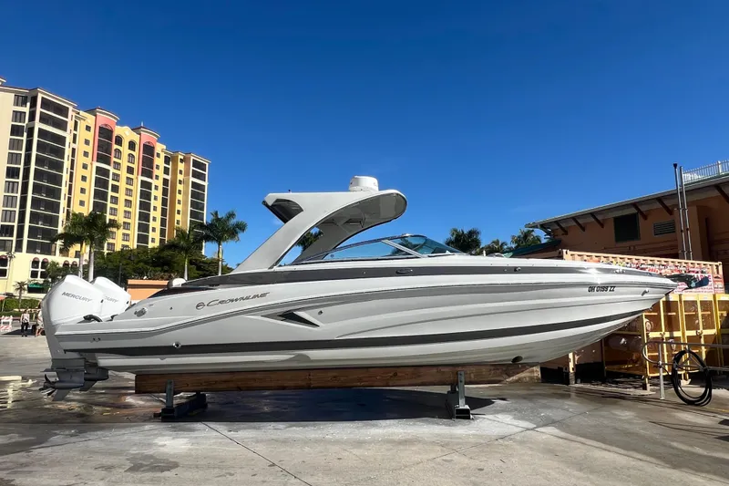 The Image of 2026 Crownline 310 XSS boat displayed outdoors on a sunny day. - 0