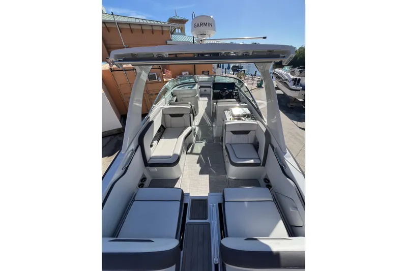 Slide: The Image of 2026 Crownline 310 XSS boat interior with modern seating and Garmin equipment. - 16
