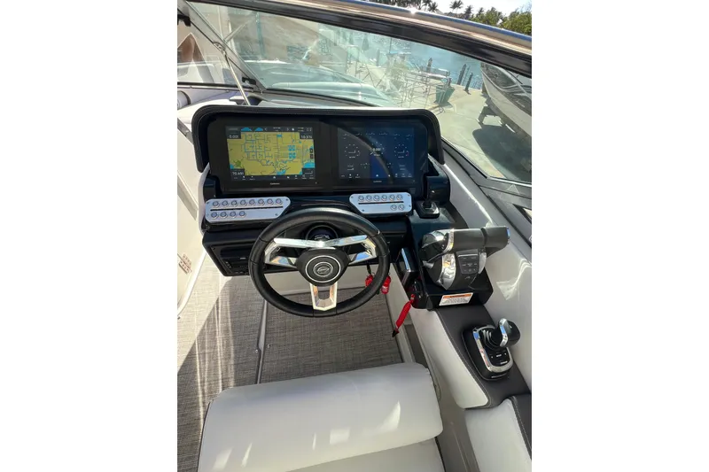 Slide: The Image of Cockpit of 2026 Crownline 310 XSS boat with advanced navigation displays and controls. - 23