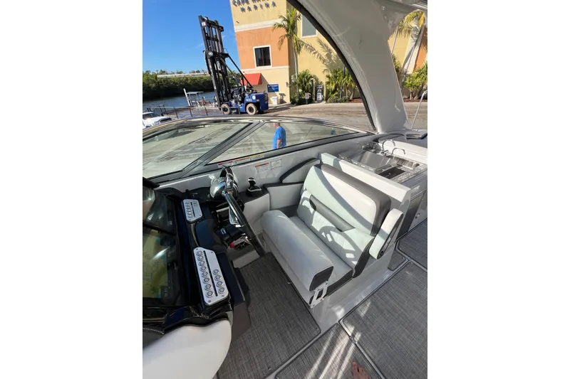 Slide: The Image of Interior view of 2026 Crownline 310 XSS boat, featuring helm and seating area. - 26