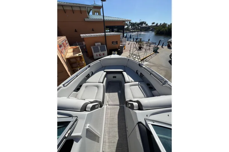 Slide: The Image of 2026 Crownline 310 XSS boat interior with gray seating and waterfront view. - 29